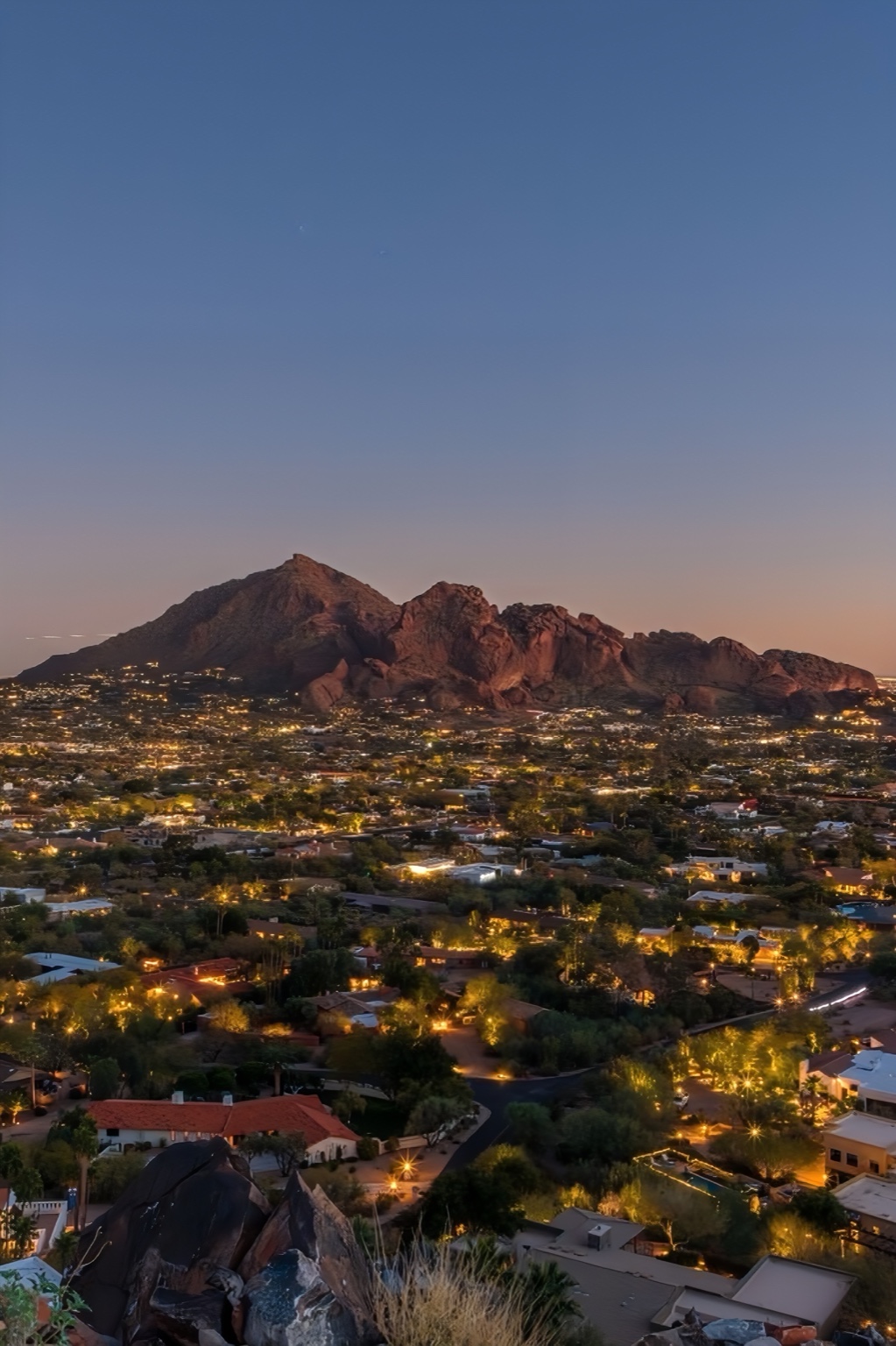 Phoenix skyline at sunset with city lights.